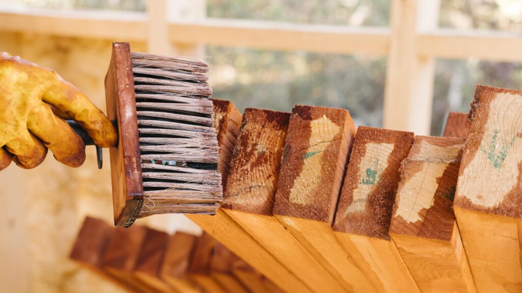 person-wearing-protection-gloves-varnishing-wood